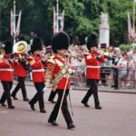 A british band is marching in a colorful parade.